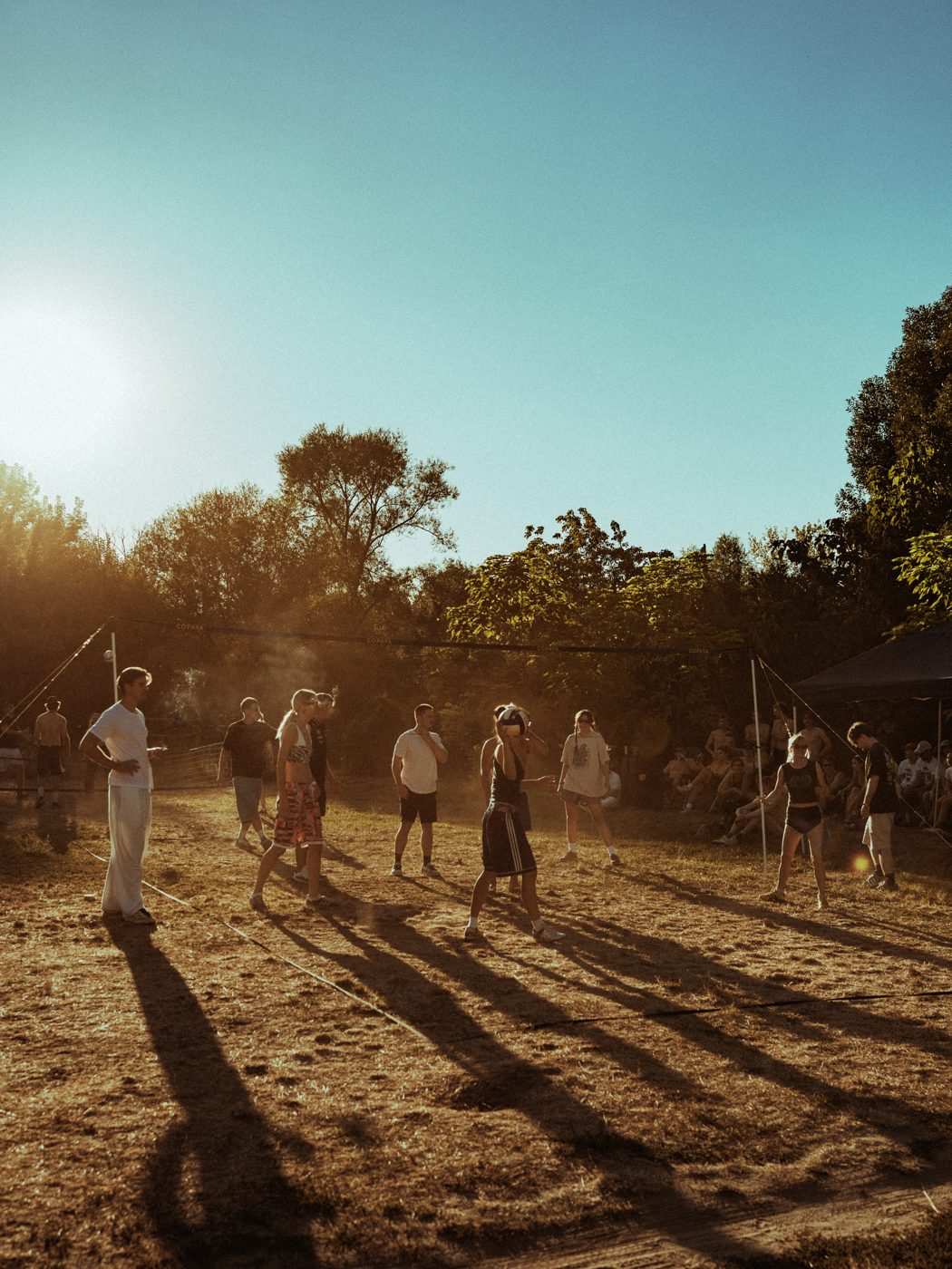 Guests playing volleyball in golden evening light